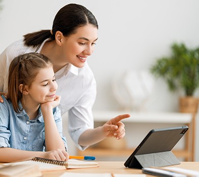 mother teaching daughter at home